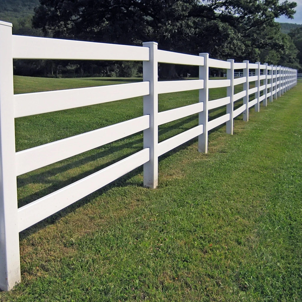 Long four-rail white vinyl fence style installation on a large property near Fort Wayne, Indiana