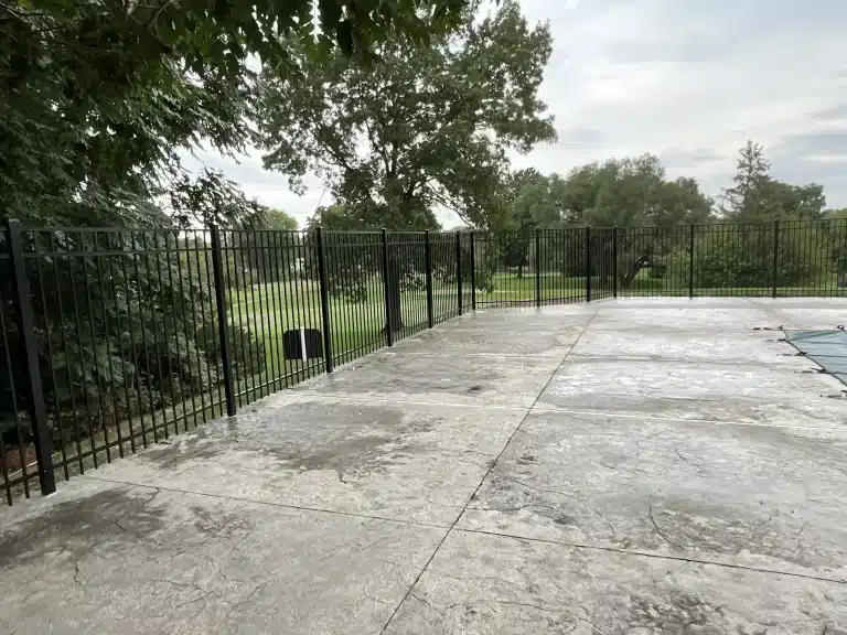 Long run of ornamental black aluminum pool fence installation in Fort Wayne, Indiana