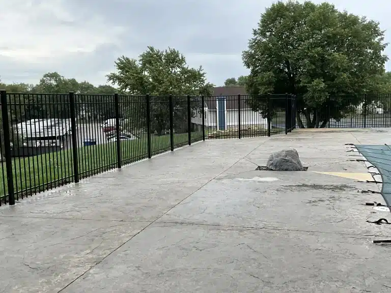 Long stretch of black aluminum pool fencing installed in Fort Wayne, Indiana